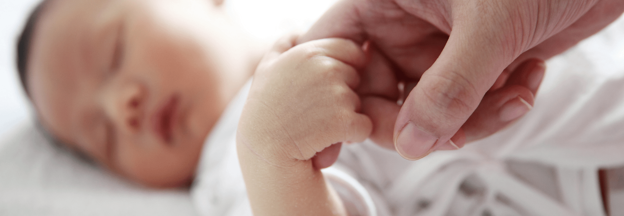 Mother holding a new born baby's hand Mother holding a new born baby's hand