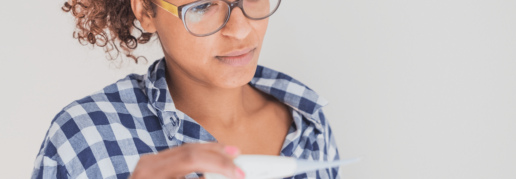 Woman looking at a pregnancy test Woman looking at a pregnancy test